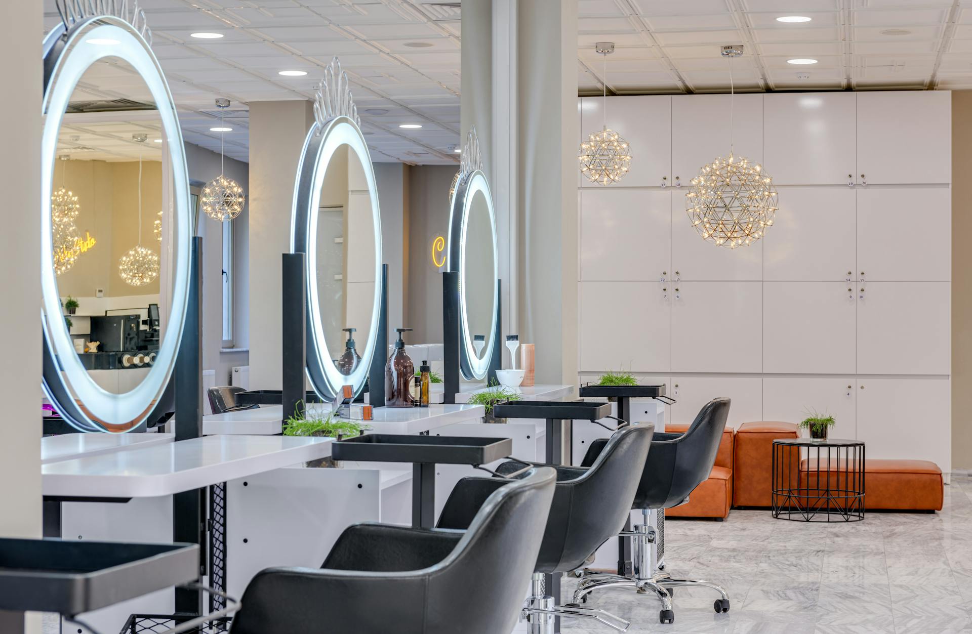 04 Salón de R&C Beauty College en Pflugerville con estaciones de trabajo y espejos iluminados